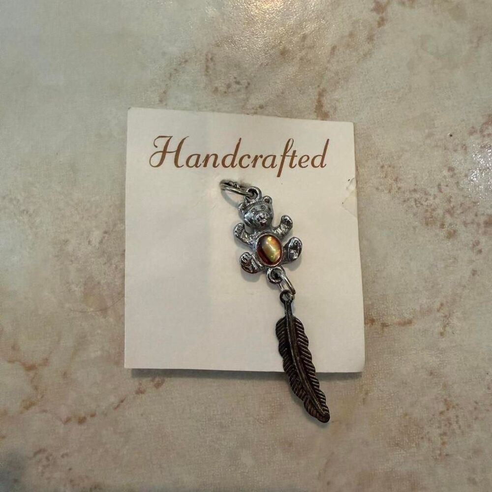 Handcrafted silver bear and feather pendant necklace